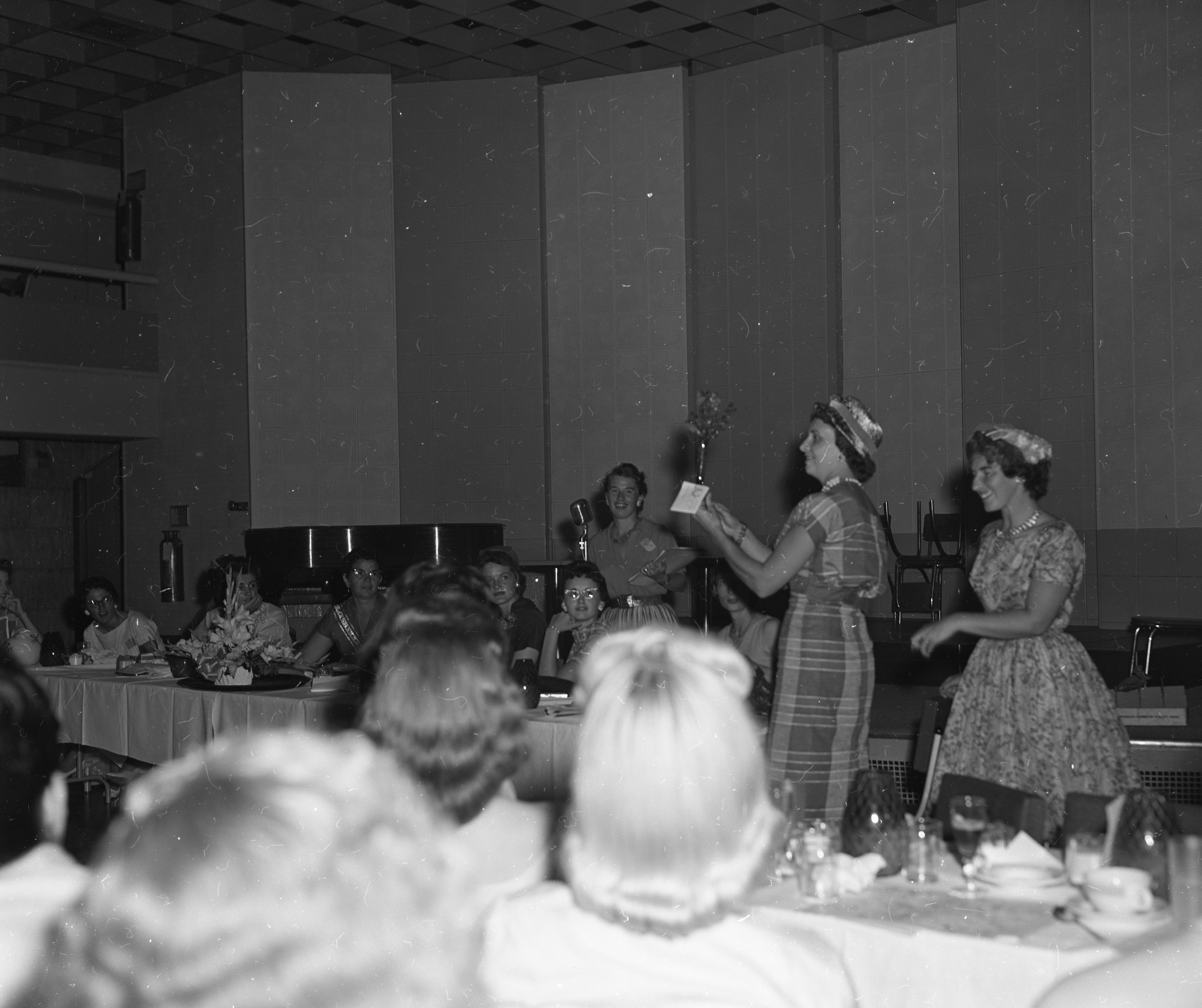 Two women presenting during luncheon.