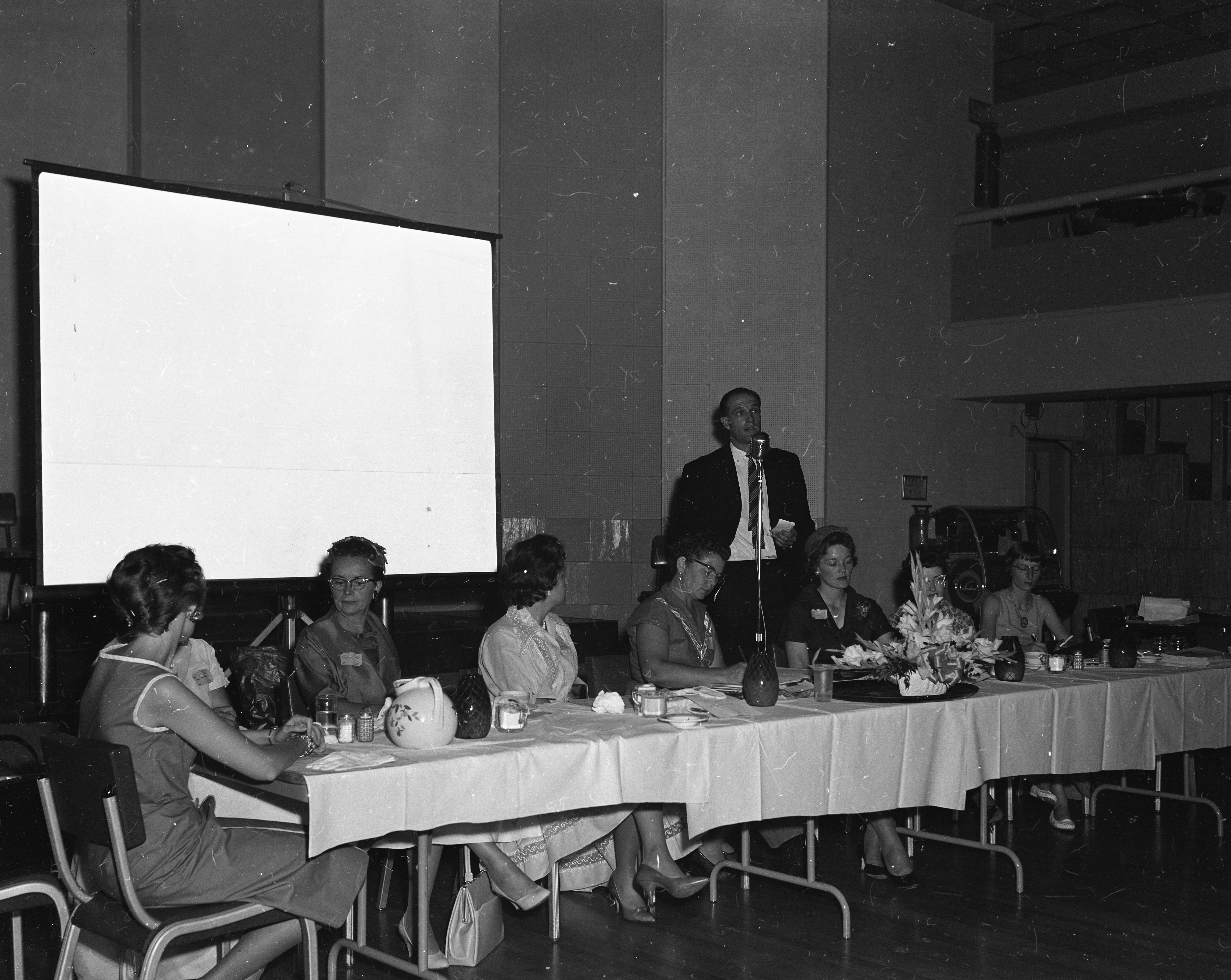 Women at head table looking bored during Convair employee speech.